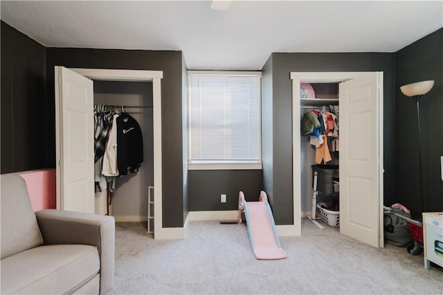 bedroom with baseboards and light colored carpet