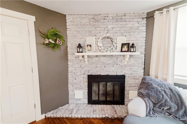 details featuring a fireplace and wood finished floors