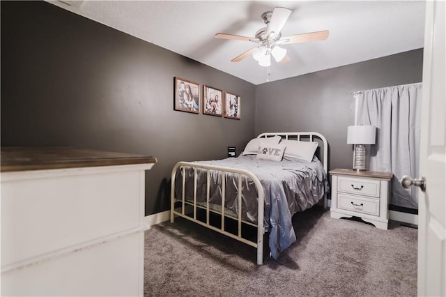 carpeted bedroom featuring ceiling fan and baseboards