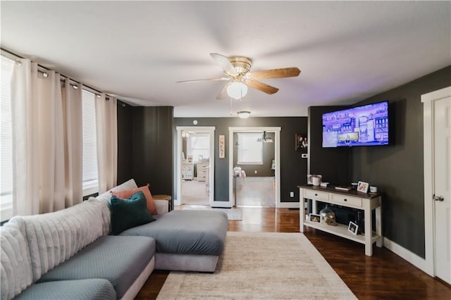 living room with ceiling fan, wood finished floors, and baseboards