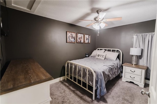 carpeted bedroom featuring ceiling fan and baseboards