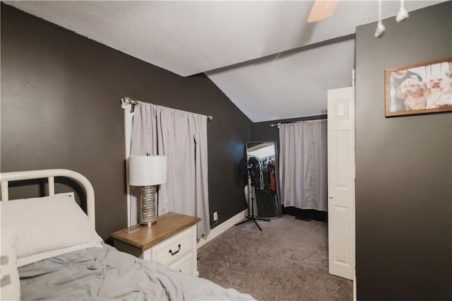 bedroom featuring carpet floors, vaulted ceiling, and a ceiling fan