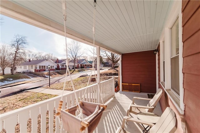 exterior space featuring a porch and a residential view