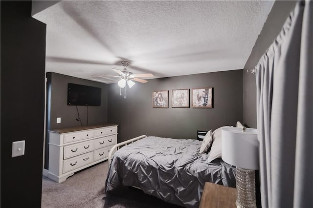 bedroom featuring a textured ceiling, ceiling fan, and carpet