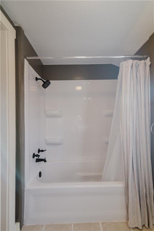 bathroom featuring shower / bath combo and tile patterned floors