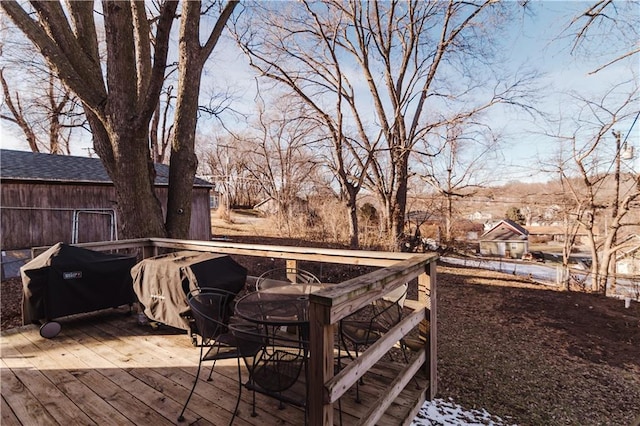 wooden terrace with outdoor dining space and area for grilling