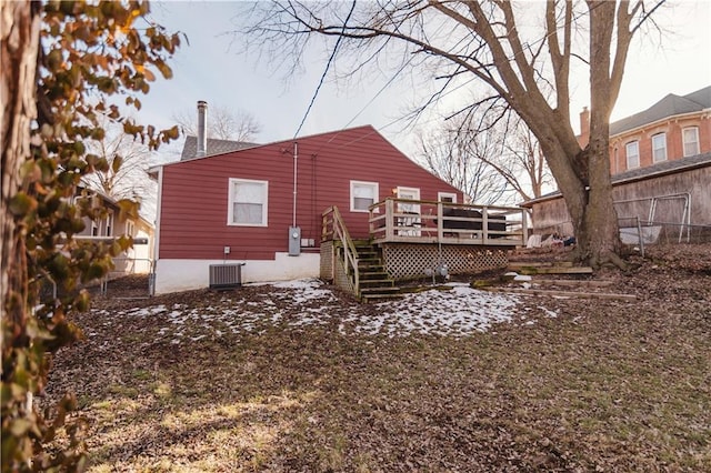 rear view of property featuring a deck, central AC, fence, and stairs