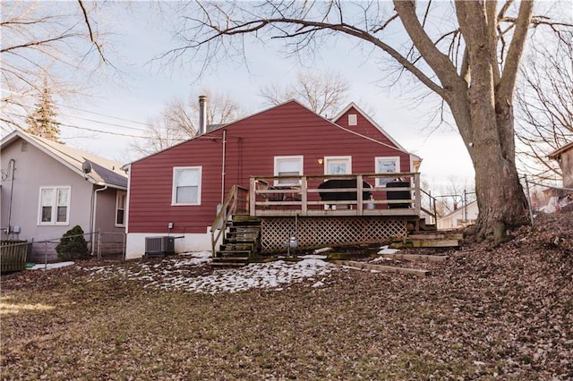 back of property with fence, a deck, and central air condition unit