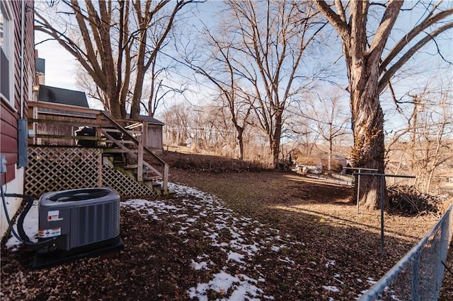 view of yard featuring central AC unit and a deck