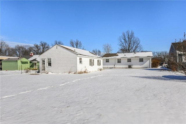 snow covered house with a residential view