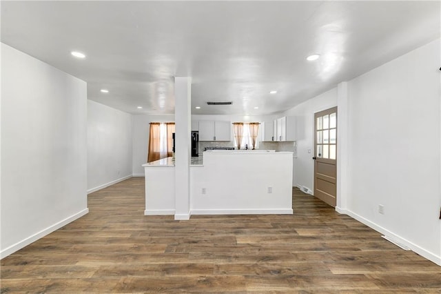 kitchen featuring recessed lighting, white cabinetry, light countertops, dark wood-style floors, and tasteful backsplash