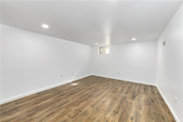 unfurnished room with recessed lighting, dark wood finished floors, visible vents, and baseboards