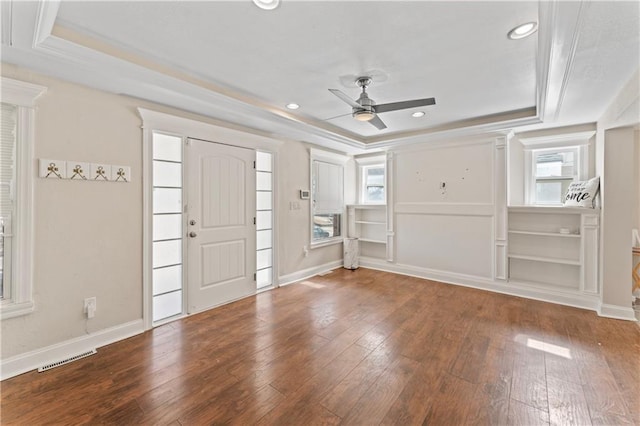 foyer entrance with a raised ceiling, baseboards, and hardwood / wood-style flooring