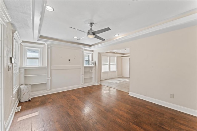 empty room with recessed lighting, a raised ceiling, ceiling fan, baseboards, and hardwood / wood-style flooring