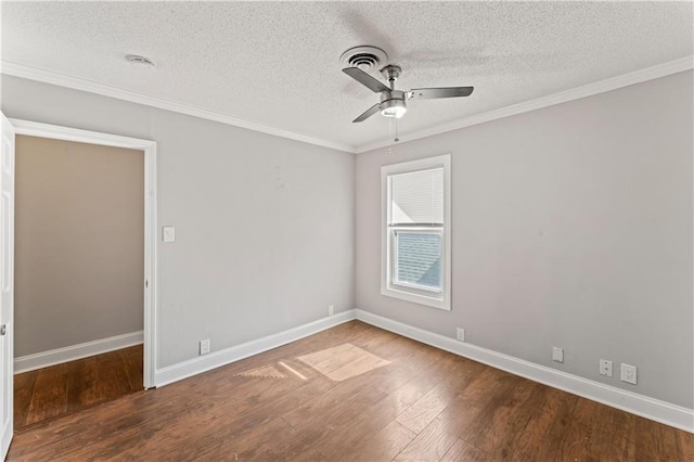 empty room with hardwood / wood-style flooring, ceiling fan, baseboards, and crown molding