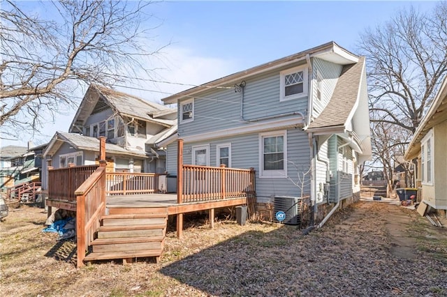 back of property featuring roof with shingles, central AC unit, and a wooden deck