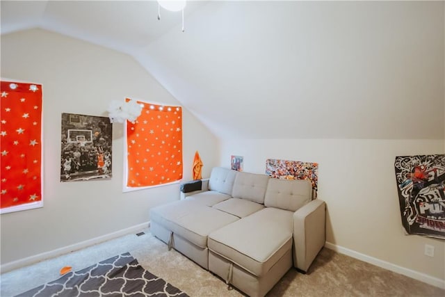 interior space featuring baseboards, vaulted ceiling, and light colored carpet