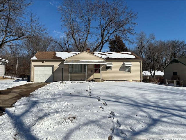 view of front of property with a garage, entry steps, and a chimney