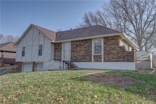 view of front of home with a garage, brick siding, and a front yard