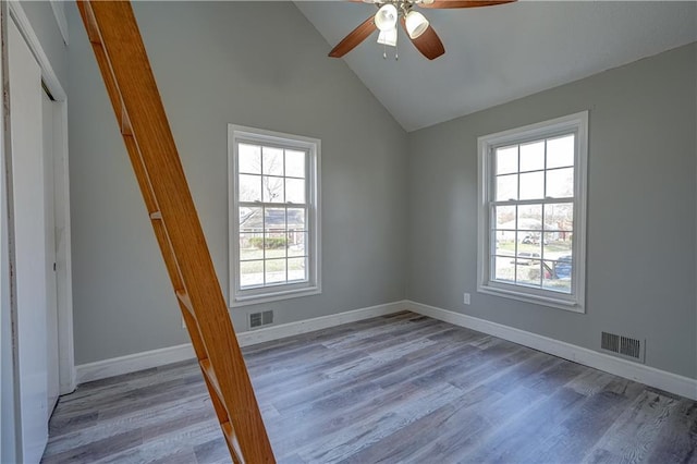 spare room with light wood-type flooring, baseboards, visible vents, and ceiling fan