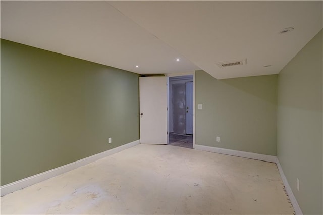 empty room with visible vents, baseboards, and unfinished concrete floors