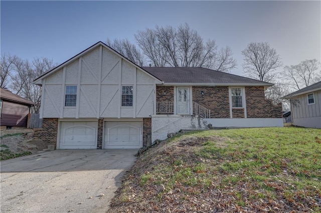 view of front of property featuring a front yard, an attached garage, brick siding, and driveway