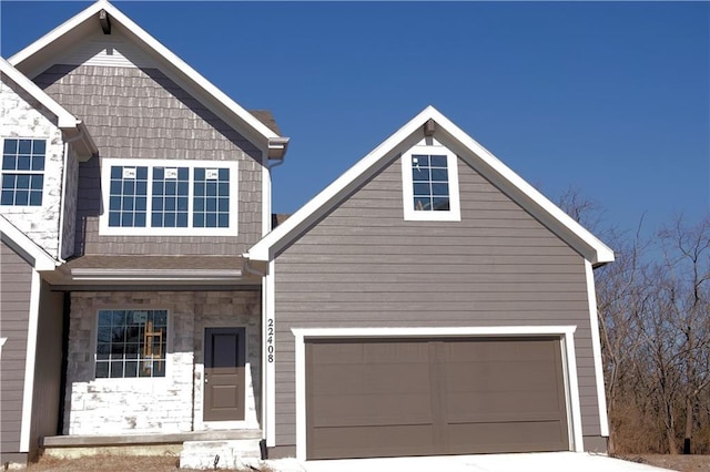 view of front of home with a garage and stone siding