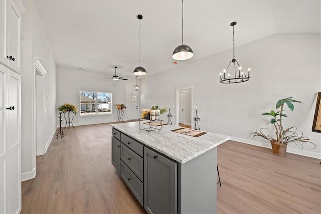 kitchen with light wood-style flooring, white cabinetry, open floor plan, gray cabinets, and a center island