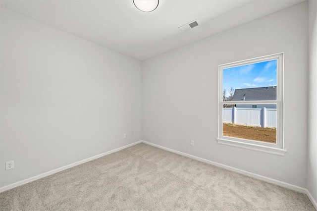 unfurnished room featuring carpet floors, baseboards, and visible vents