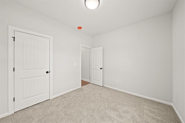 unfurnished bedroom with carpet and baseboards