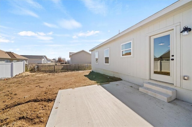 view of yard with entry steps, a patio area, a fenced backyard, and a residential view