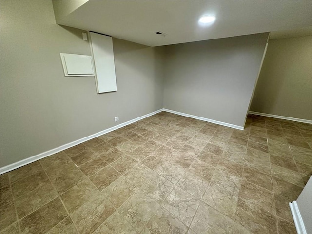 finished basement with baseboards and visible vents