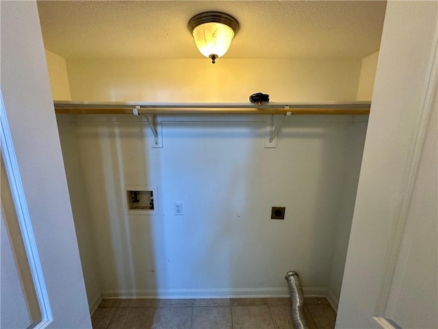 washroom featuring a textured ceiling, baseboards, hookup for a washing machine, and hookup for an electric dryer