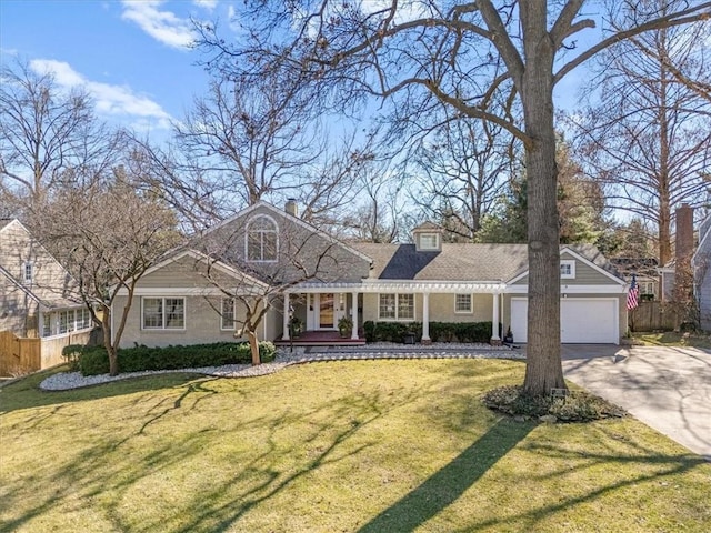 view of front facade with a garage, a front yard, concrete driveway, and fence