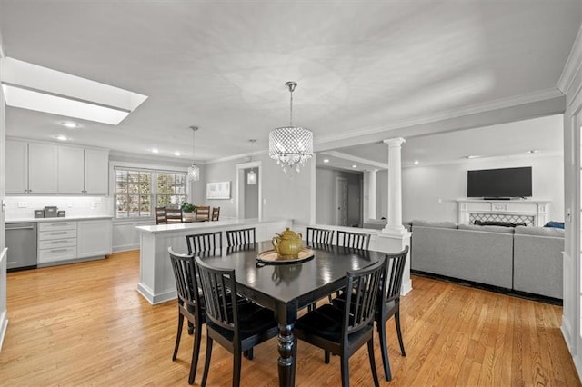 dining area with ornate columns, ornamental molding, light wood finished floors, and recessed lighting