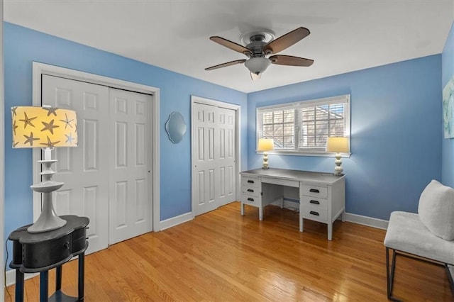 living area featuring light wood-style floors, ceiling fan, and baseboards