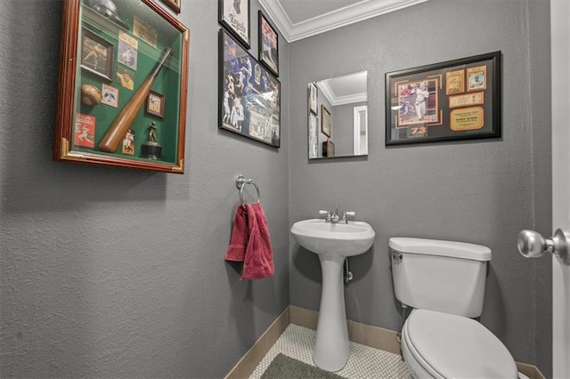 half bath featuring ornamental molding, baseboards, a textured wall, and toilet