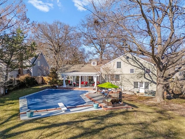 view of swimming pool featuring a patio area, a lawn, and a pergola