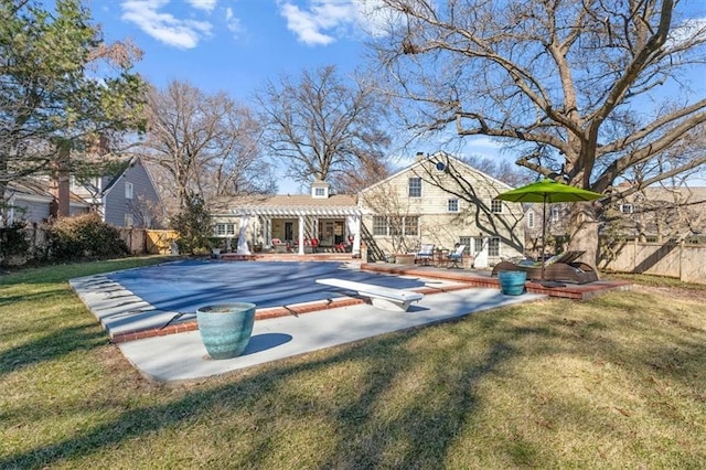 view of pool with a yard, a patio area, fence, and a pergola