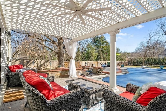 view of patio / terrace with an outdoor living space with a fire pit, a fenced backyard, and a pergola