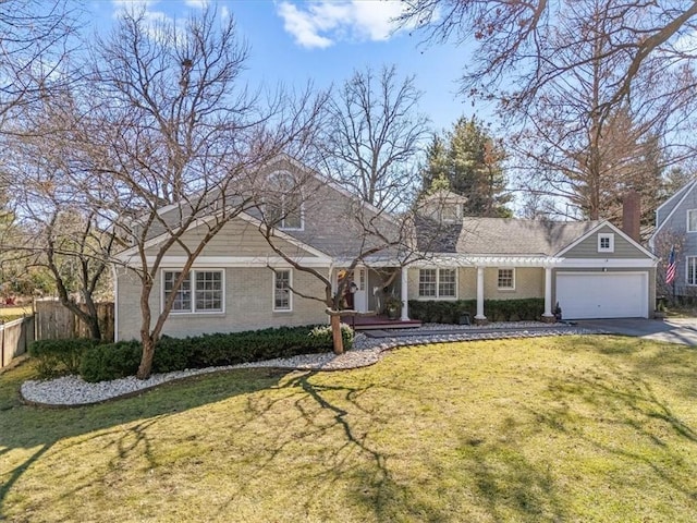 view of front of house with a garage, brick siding, fence, concrete driveway, and a front yard