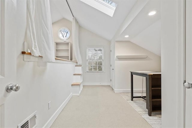 corridor with vaulted ceiling with skylight, visible vents, baseboards, carpet floors, and recessed lighting