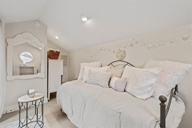 bedroom featuring light carpet, baseboards, and vaulted ceiling