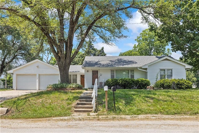 ranch-style house featuring a garage, a front lawn, and concrete driveway