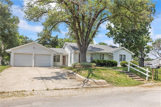 ranch-style house with concrete driveway and an attached garage