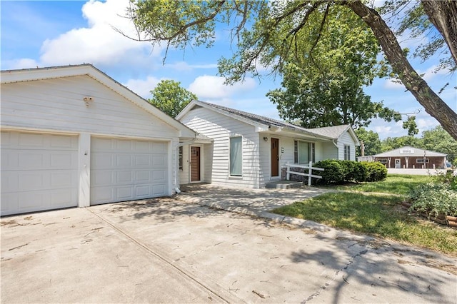 ranch-style house featuring driveway and an attached garage