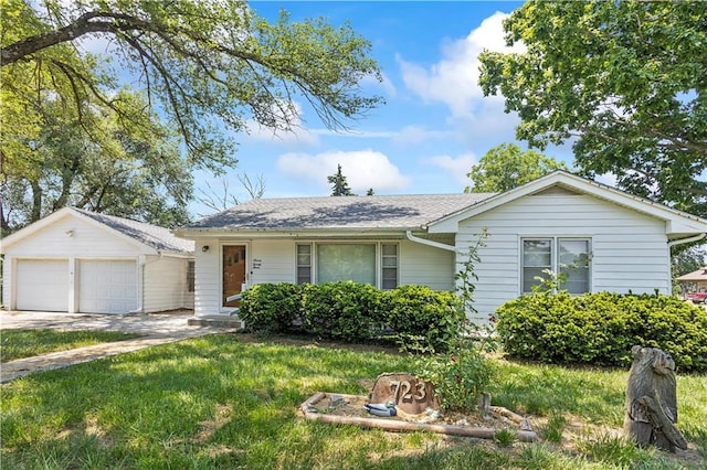 ranch-style home featuring a shingled roof, an outbuilding, and a front yard