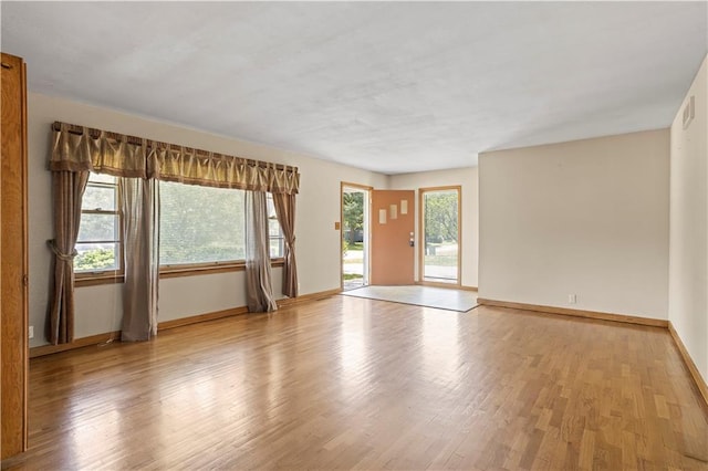 unfurnished room featuring light wood-style floors and baseboards