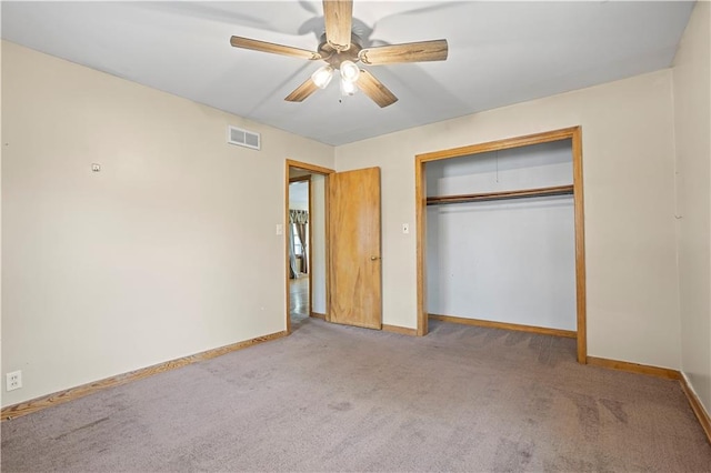 unfurnished bedroom featuring a closet, light carpet, ceiling fan, and baseboards