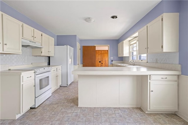 kitchen featuring light countertops, decorative backsplash, a peninsula, white appliances, and under cabinet range hood